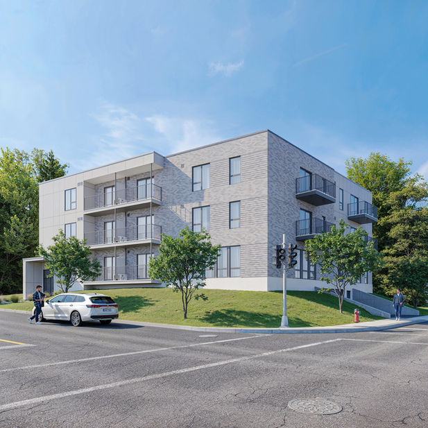 Immeuble résidentiel moderne en briques grises avec balcons.