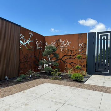 Custom outdoor entrance landscaping with architectural stone feature by Quant Landscaping