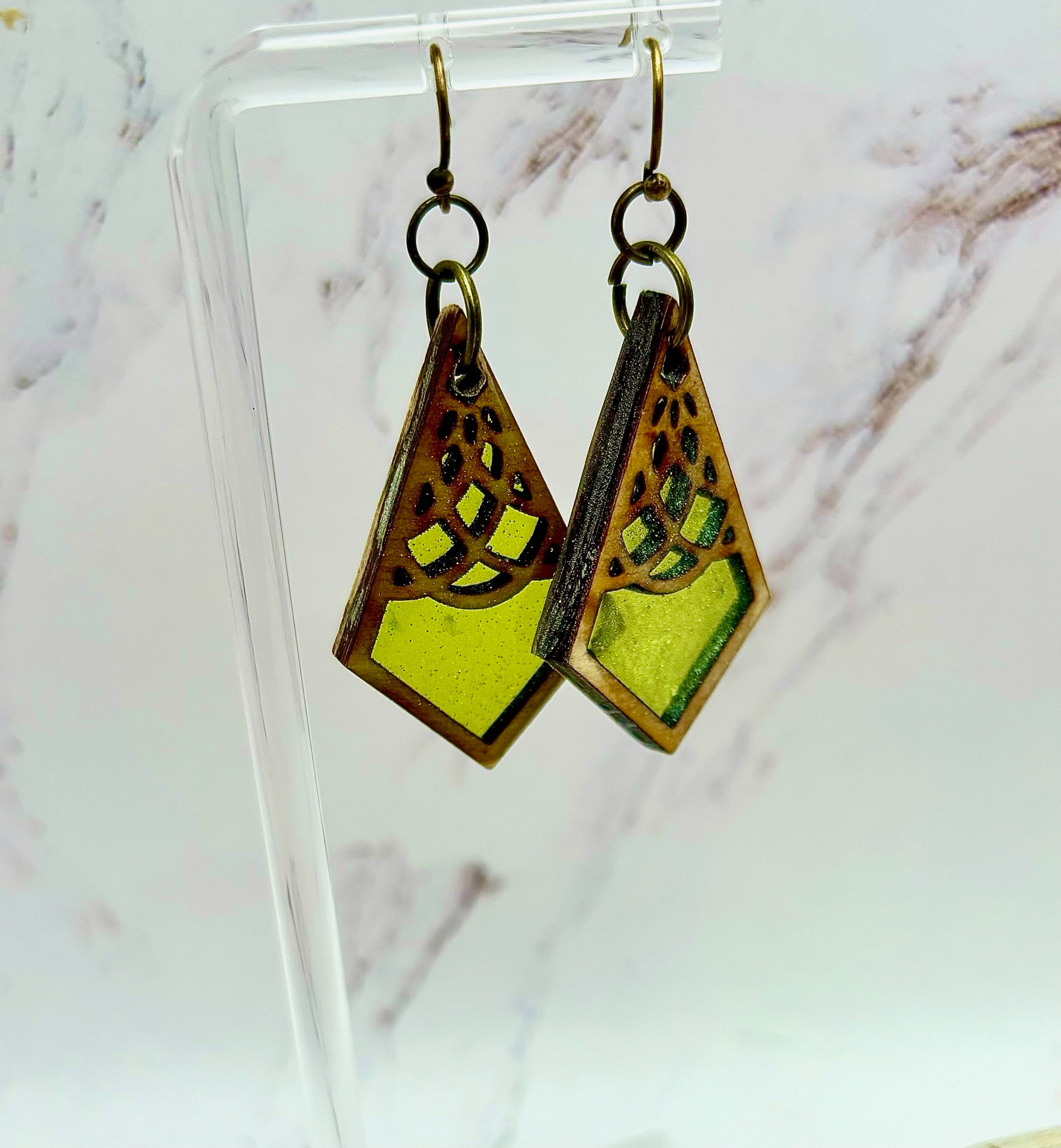 Pair of unique dangle earrings, featuring yellow and bronze geometric shapes.