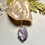 Thumbnail: Elegant Yttrium Fluorite Pendant Necklace with a light purple stone on display.