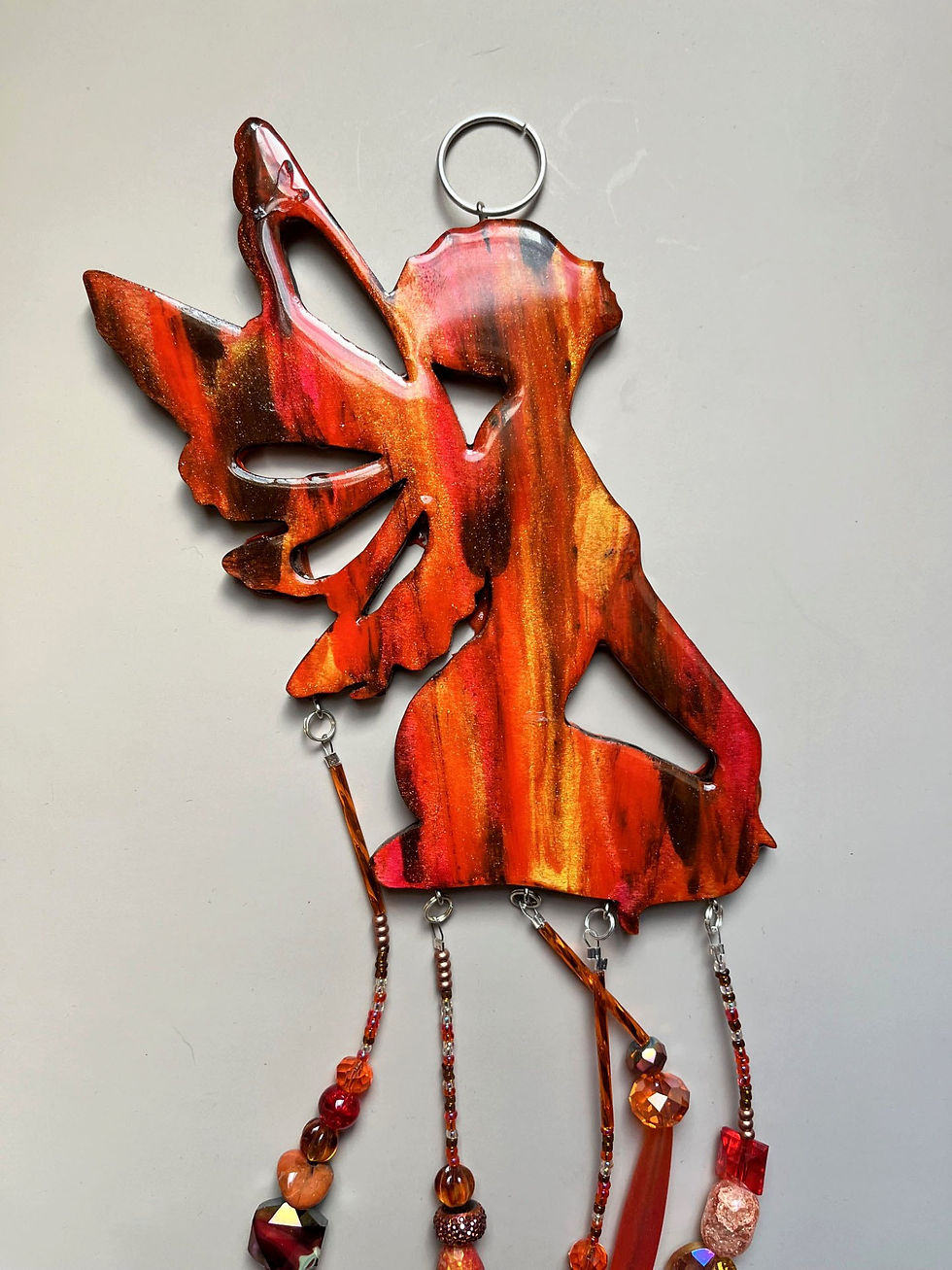 Miniature : Orange fairy wind chime with beads; a beautiful art piece displayed.
