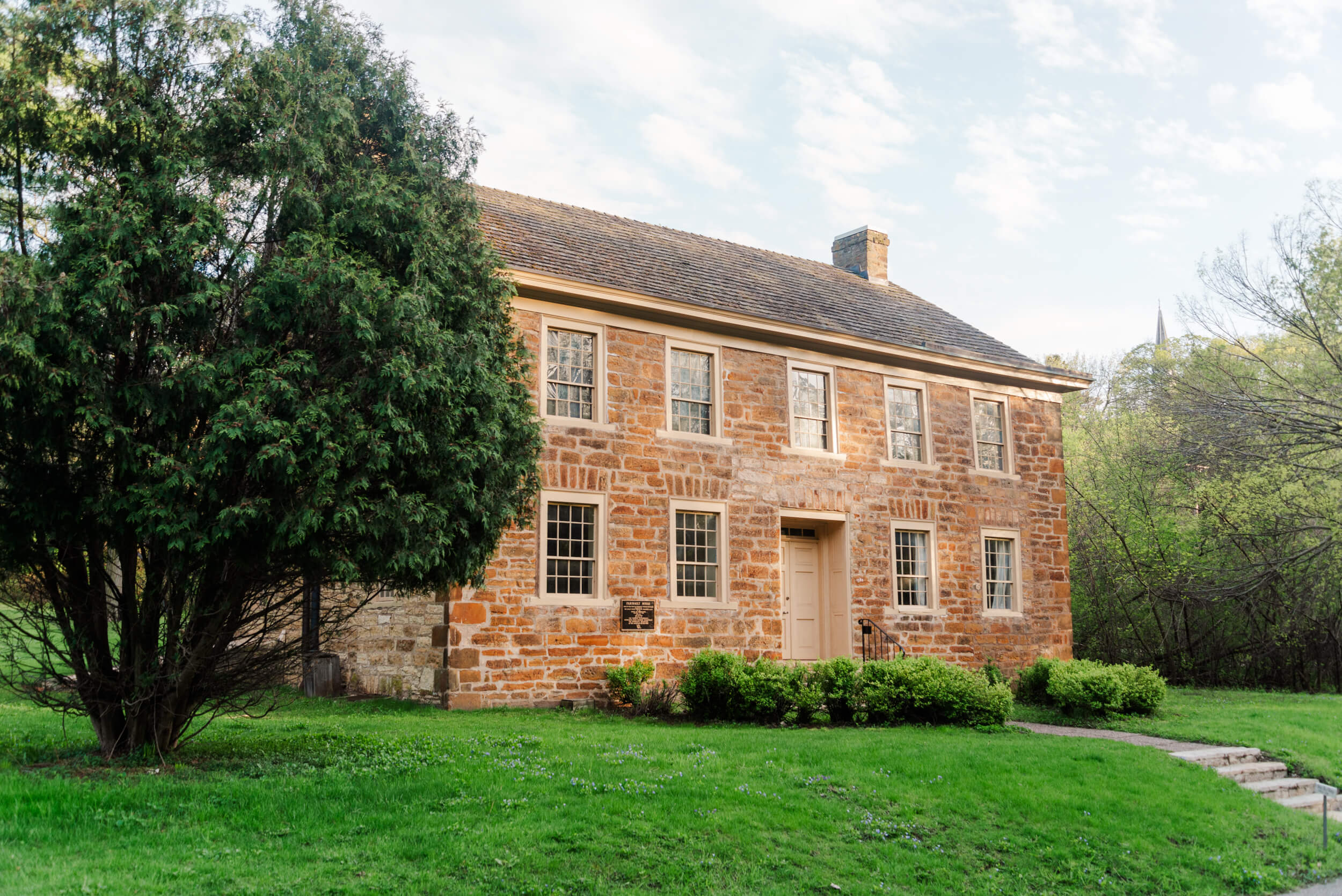 Scenic regional view connecting local historic sites to broader Minnesota heritage trail markers, encouraging visitors to explore the state's enduring cultural legacy.