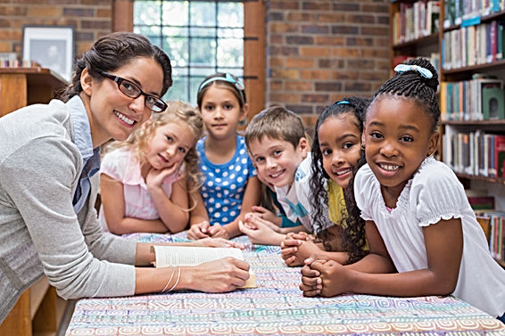 cute-pupils-teacher-reading-library.jpg