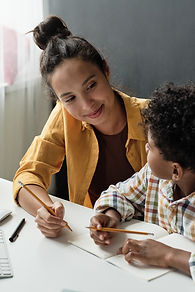 teacher-helping-boy-his-study.jpg