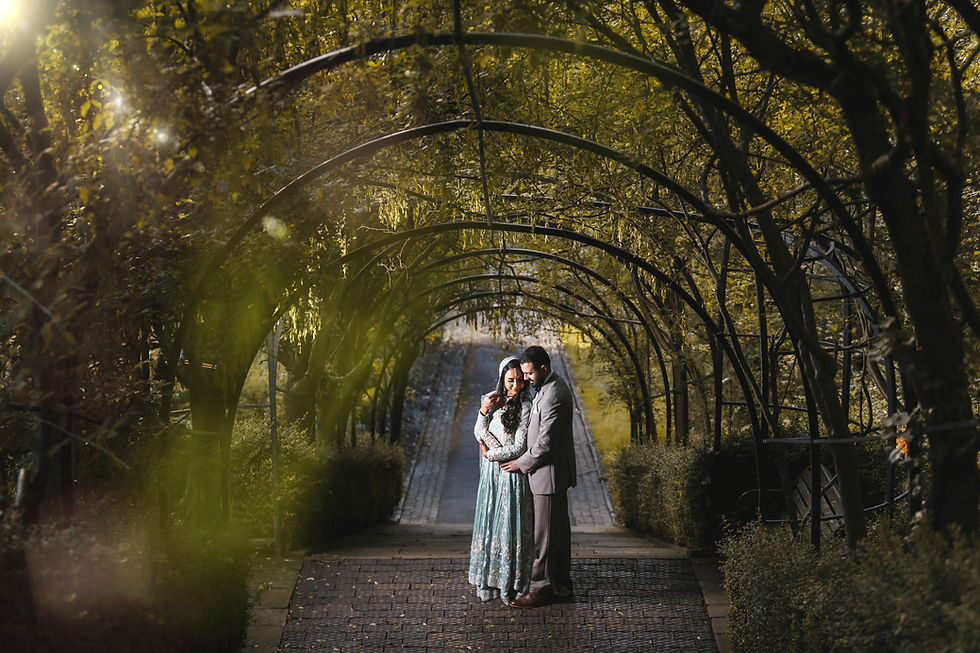 Wedding couple beneath a tree arch in Manchester, photographed by SH Media Productions