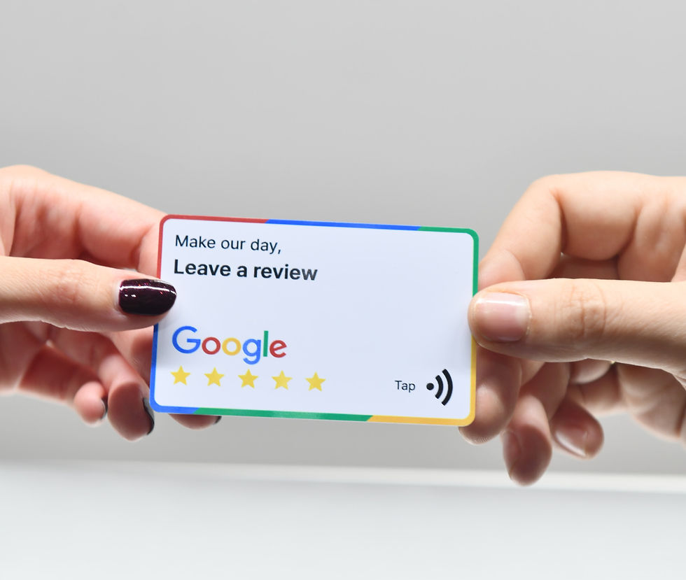 Hands hold a Google review card reading Make our day, Leave a review with five stars and Tap icon on a gray background