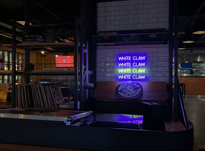 white-claw-neon-sign-behind-bar.jpg