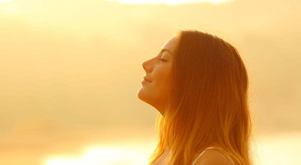 girl breathing with mindfulness staring at sun