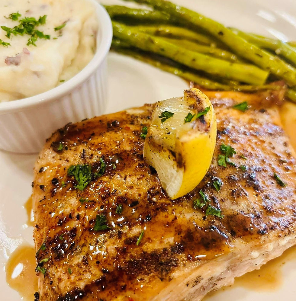 A plate of glistening roasted salmon with asparagus and mashed potatoes