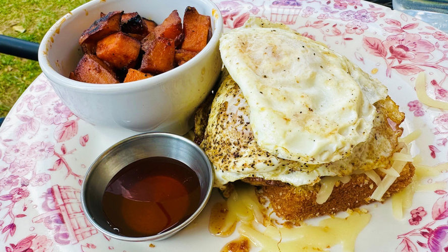 A plate of cornbread topped with an egg, cheese and hot honey at Goldenrod Kitchen in Charleston, WV