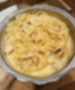 A takeout food container is filled with creamy chicken alfredo from Milano's Italian Restaurant in Charleston, WV