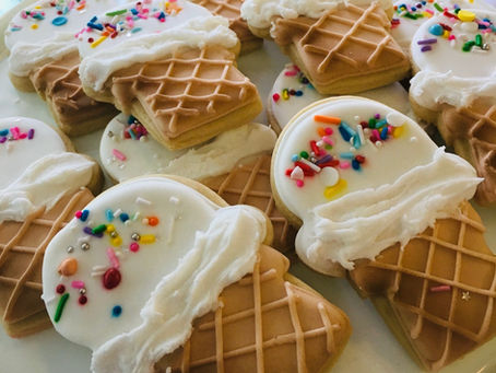 A plate of iced sugar cookies decorated like ice cream cones