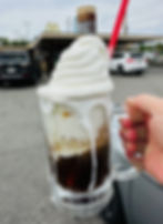 A root beer float drips down the side of a