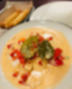A bowl of creamy yellow curry filled with vegetables and fresh herbs from Chow Thai in Charleston, WV