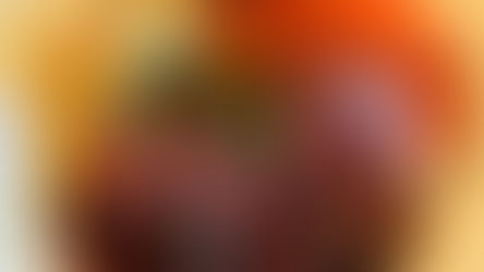 A plate of sliced steak with sauce, plus glazed carrots and smashed potatoes