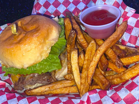 A burger and fries on a platter