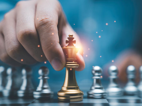 Hand holding chess piece