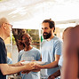 Members of a multicultural community come together, volunteering at non-profit center to d