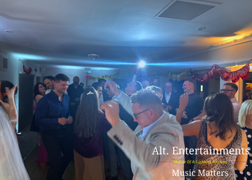 Wedding guests dancing during an evening reception at Sutton Coldfield Golf Club in Sutton Coldfield, West Midlands, with DJ entertainment provided by Alt. Entertainments Wedding DJ services.