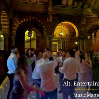 Wedding guests celebrating on the dance floor with smiles and laughter at Kelham Hall.