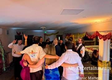 Wedding guests dancing during an evening reception at Sutton Coldfield Golf Club in Sutton Coldfield, West Midlands, with DJ entertainment provided by Alt. Entertainments Wedding DJ services.