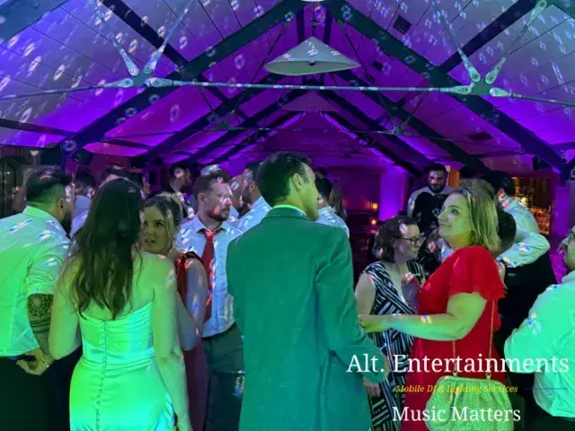 Guests dancing joyfully on the dance floor at Grangefields Barn, Ashbourne, Derbyshire, during a wedding reception with professional DJ services by Alt. Entertainments, a Wedding DJ and Mobile DJ Company.
