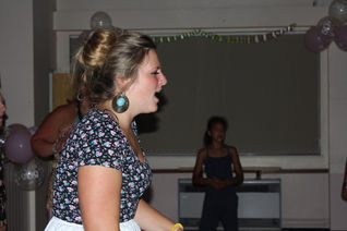 A dynamic scene at St. George's Sports & Social Club in Telford, Shropshire, captured by Alt. Entertainments. Dancers showcase their energetic moves on the illuminated dance floor at a vibrant birthday disco. Alt. Entertainments specializes in creating memorable events with their mobile DJ, disco, and event services.