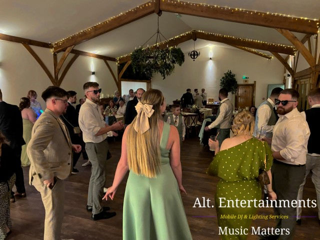 Colorful dancers performing joyfully at Coton House Farm wedding, photographed by Alt. Entertainments Wedding DJ/Mobile DJ, Disco & Events Company in Whittington, Lichfield, Staffordshire.