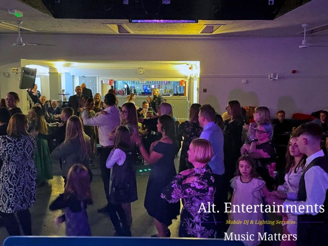 A lively atmosphere ensues as guests joyfully dance at a wedding disco, set against the backdrop of Pelsall Cricket Club, immortalized by Alt. Entertainments, a leading Mobile DJ Disco & Events Company.