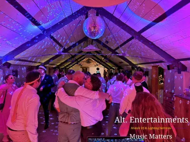 Wedding guests dancing and enjoying themselves at Grangefields Barn, Ashbourne, Derbyshire, with professional wedding DJ and entertainment by Alt. Entertainments.