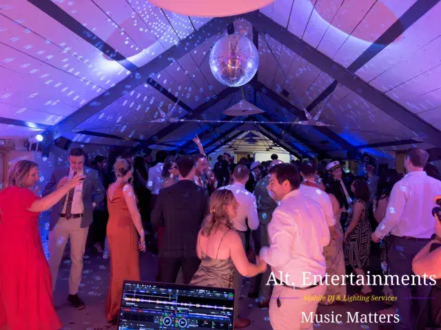 Wedding guests dancing and celebrating at Grangefields Barn in Ashbourne, Derbyshire, with professional DJ services provided by Alt. Entertainments.