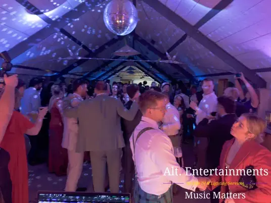 Guests celebrating on the dance floor during a wedding at Grangefields Barn in Ashbourne, Derbyshire, with music and entertainment by Alt. Entertainments Wedding DJ and Mobile DJ company.