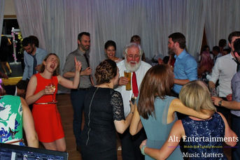 A lively crowd dancing enthusiastically at a wedding disco in Crosby, Liverpool, managed by Alt. Entertainments, a Wedding DJ, Mobile DJ, Disco, and Events Company.