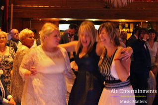 A beaming bride surrounded by friends and family at a wedding disco held at Hundred House, Telford/Bridgnorth, Shropshire. Captured by Alt. Entertainments Wedding DJ/Mobile DJ, Disco & Events.
