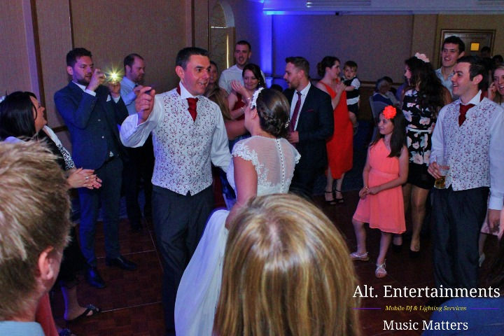 Guests dance exuberantly at a wedding disco in Ardencote Manor Hotel, Warwick, Warwickshire. The photo captures the radiant energy of the celebration, with guests immersed in joyful movement on the dance floor. Taken by Alt. Entertainments, a mobile DJ, Disco & Events Company. #WeddingDisco #ArdencoteManor #DanceCelebration