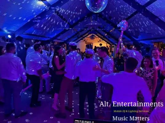 Wedding guests dancing and enjoying a lively reception at Grangefields Barn, Ashbourne, Derbyshire, with professional DJ and entertainment services by Alt. Entertainments, a Wedding DJ and Mobile DJ Company.