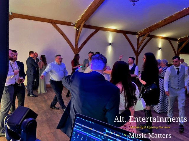 Colorful dancers performing joyfully at Coton House Farm wedding, photographed by Alt. Entertainments Wedding DJ/Mobile DJ, Disco & Events Company in Whittington, Lichfield, Staffordshire.