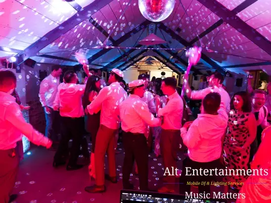 Wedding guests dancing and celebrating at Grangefields Barn, Ashbourne, Derbyshire, with professional entertainment and DJ services provided by Alt. Entertainments, a Wedding DJ and Mobile DJ Company.