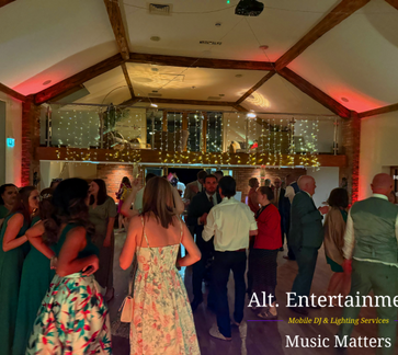 Wedding guests dancing on a packed dancefloor during an evening reception at Wootton Park in Henley-in-Arden, Warwickshire, with professional DJ entertainment by Alt. Entertainments Wedding DJ services.