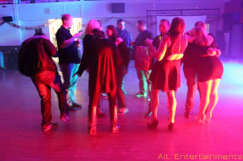 A lively image capturing people dancing at a disco, taken by Alt. Entertainments at Pelsall Labour Club, showcasing the vibrant atmosphere and energetic vibe of the event.
