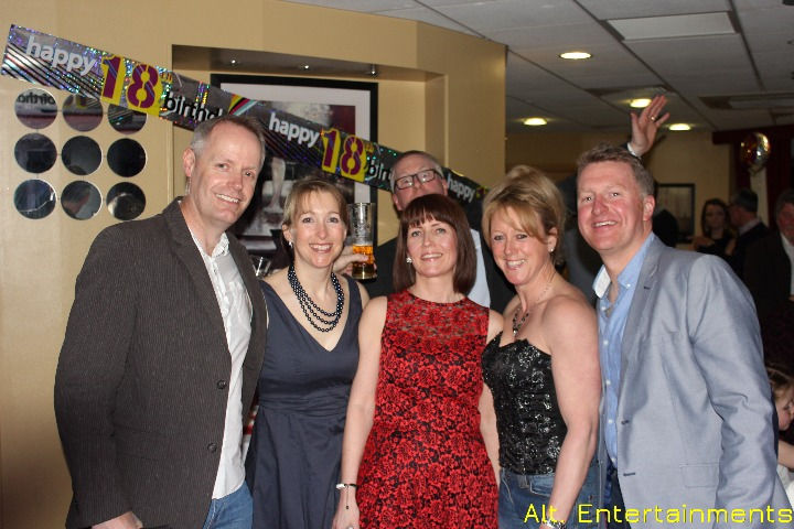A group of people posing for a photo at The Sky Bar, Ramada (Now Holiday Inn), captured by Alt. Entertainments Mobile DJ, Disco & Events.