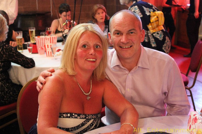 Group of people posing for a photo at Chester Guild Hall, Cheshire. The image, taken by Alt. Entertainments, shows a festive atmosphere with the historic venue in the background. The photo highlights the company’s role in providing mobile DJ, disco, and event services.