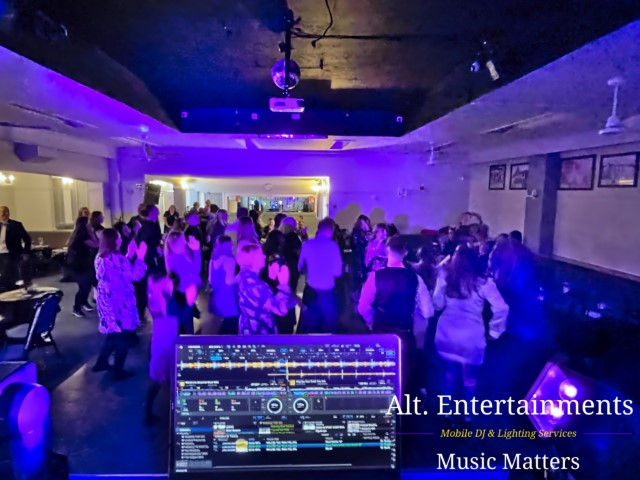 Vibrant image of people dancing joyfully at a wedding disco, set against the backdrop of Pelsall Cricket Club, captured by Alt. Entertainments, a trusted Mobile DJ Disco & Events Company.
