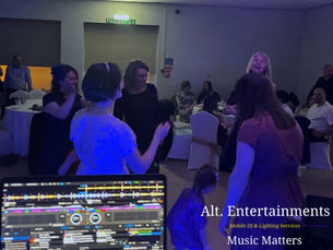 Wedding guests dancing energetically at Wolverhampton Lawn Tennis & Squash Club in Tettenhall. The lively photo, taken by Alt. Entertainments Wedding DJ/Mobile DJ, Disco & Events Company, captures the festive, joyous atmosphere of the wedding reception.