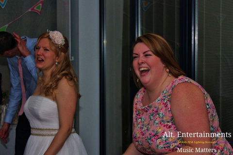 Energetic crowd dancing at St Johns Luxury Bed & Breakfast wedding disco in Lichfield. The photograph encapsulates the exuberance and shared joy, highlighting the lively atmosphere of the celebration.