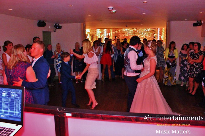 A beautiful moment unfolds as the bride and groom share their first dance as husband and wife at their indie wedding in Ashes-in-Endon, Staffordshire. The newlyweds embrace on the dance floor, surrounded by loved ones, symbolizing the start of their lifelong adventure together.