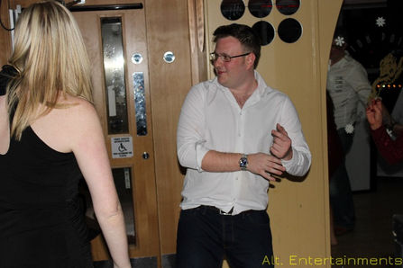 A group of people dancing energetically at The Sky Bar, previously known as The Ramada and currently a Holiday Inn in Cannock, captured by Alt. Entertainments, a Mobile DJ, Disco & Events Company.