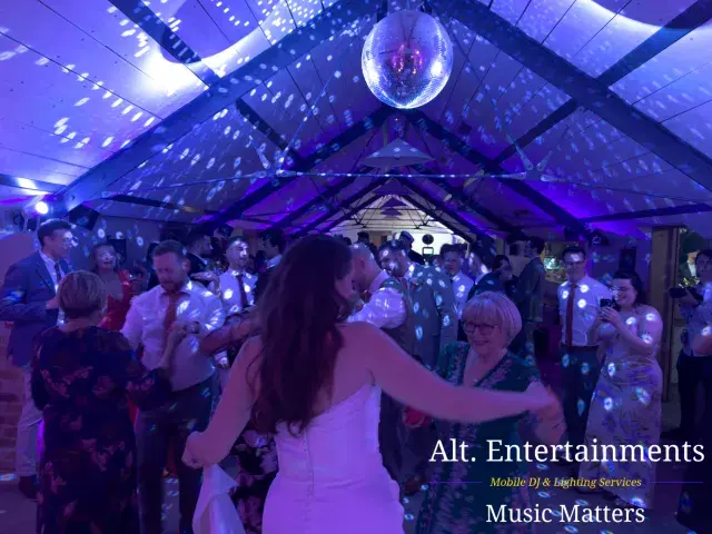 Wedding guests dancing and celebrating at Grangefields Barn in Ashbourne, Derbyshire, with professional DJ entertainment provided by Alt. Entertainments.