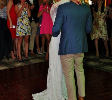 Bride and groom sharing their first dance at Beau Desert Golf Club in Cannock, Staffordshire, surrounded by family and friends.