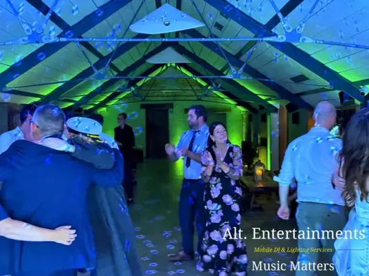 Guests dancing on the dance floor during a wedding reception at Grangefields Barn, Ashbourne, Derbyshire. Music and entertainment provided by Alt. Entertainments, a professional Wedding DJ, Mobile DJ, and Events Company.